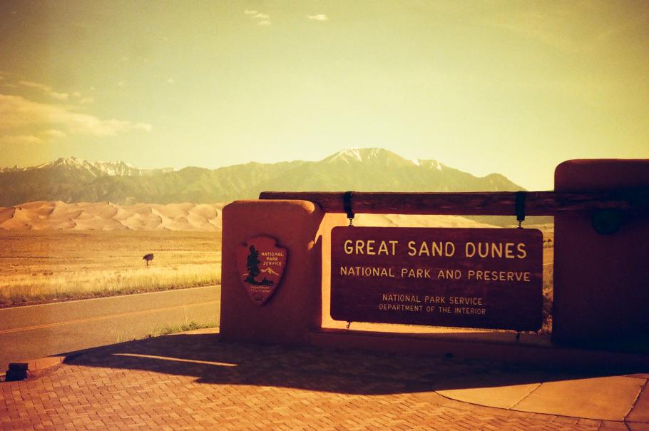 Filtered image of the welcome sign for the Great Sand Dunes. 