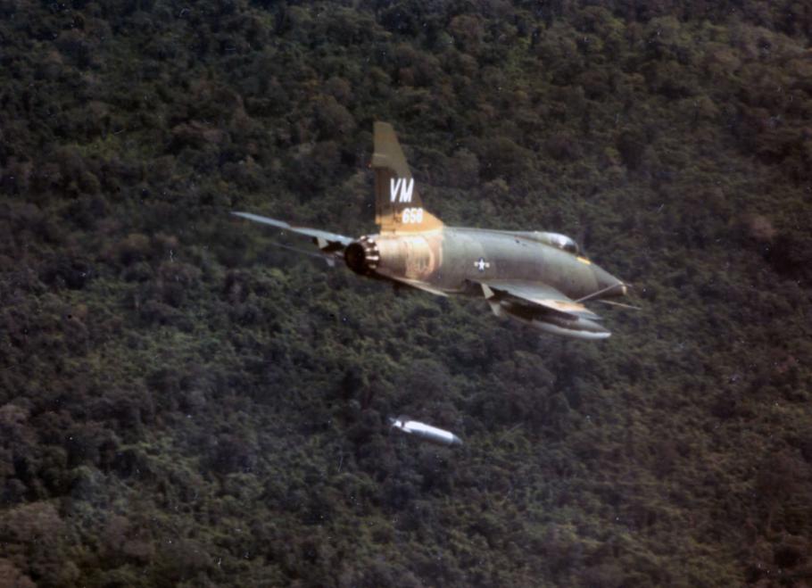 A F-100D aircraft of the 352nd Tactical Fighter Squadron dropping a napalm bomb near Bien Hoa, South Vietnam.