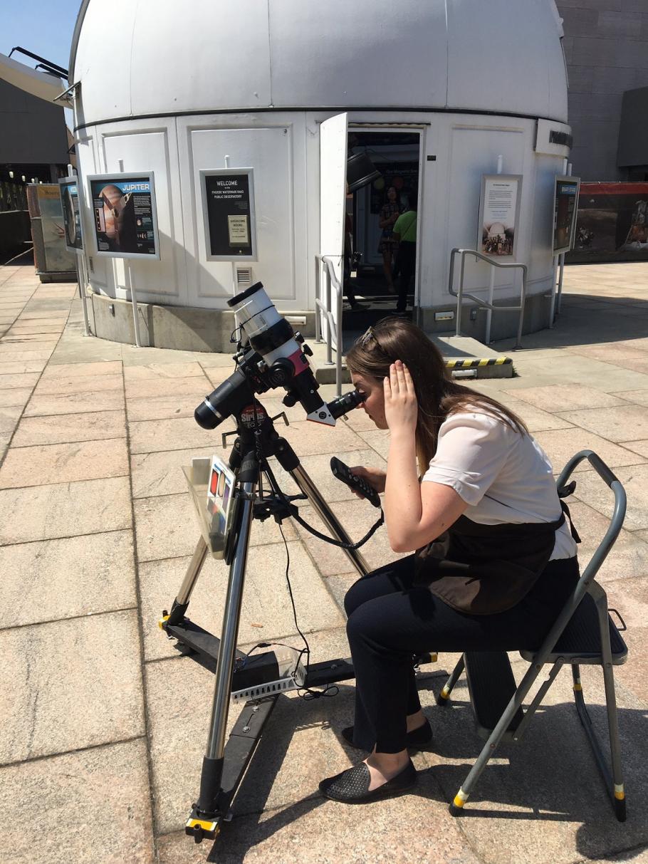 Volunteer Anne Ahrendsen using a telescope outside of the Phoebe Waterman Haas Public Observatory.