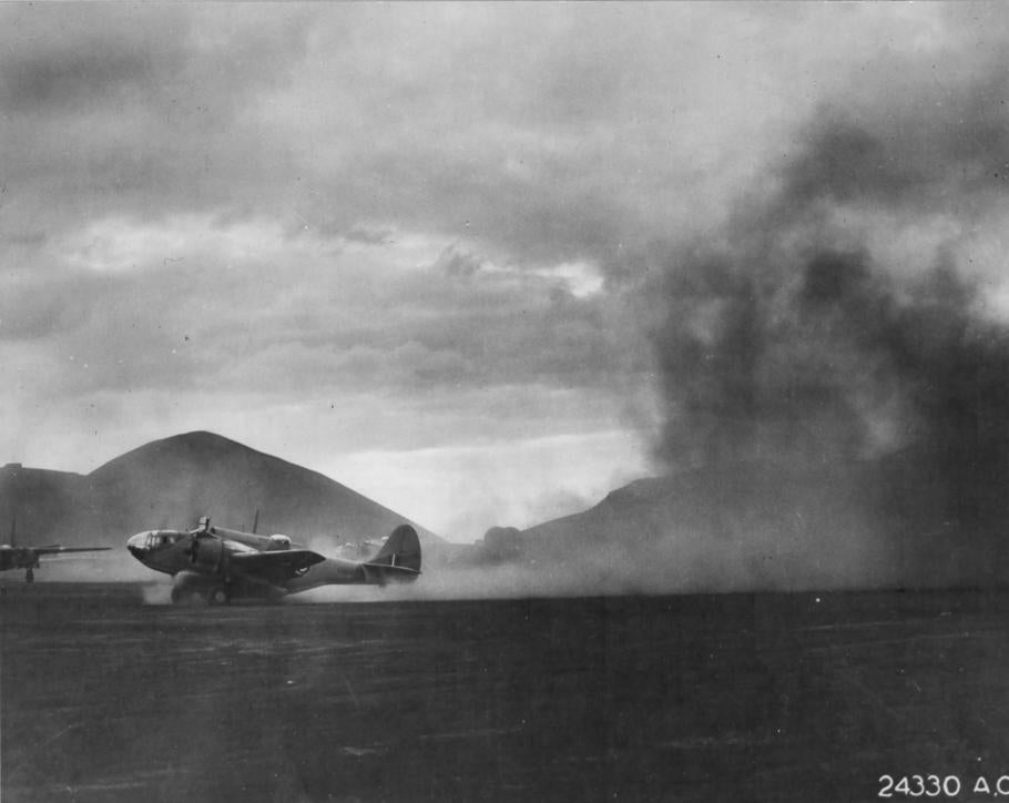 A U.S.-built Martin 167 kicks up dust during takeoff on Ascension Island