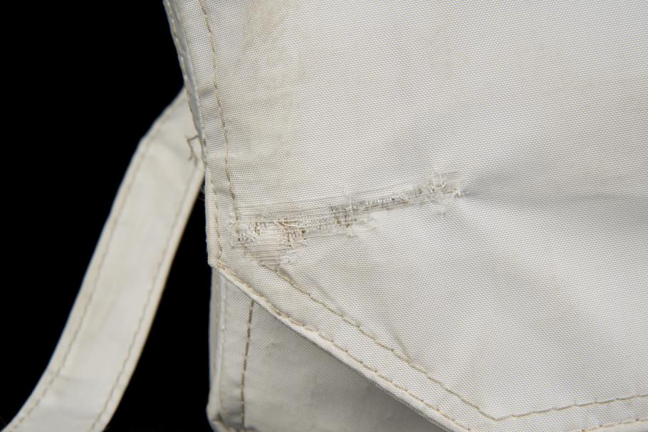 Detail view of repair made to the tear in Beta cloth medical container. 