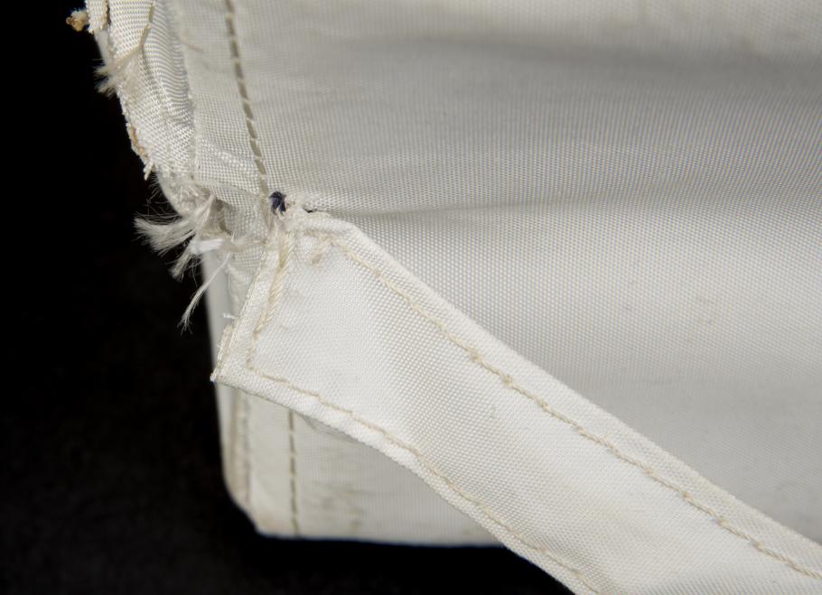 View of the handling strap on the back of the Apollo 11 medical accessory kit before it underwent conservation treatment.