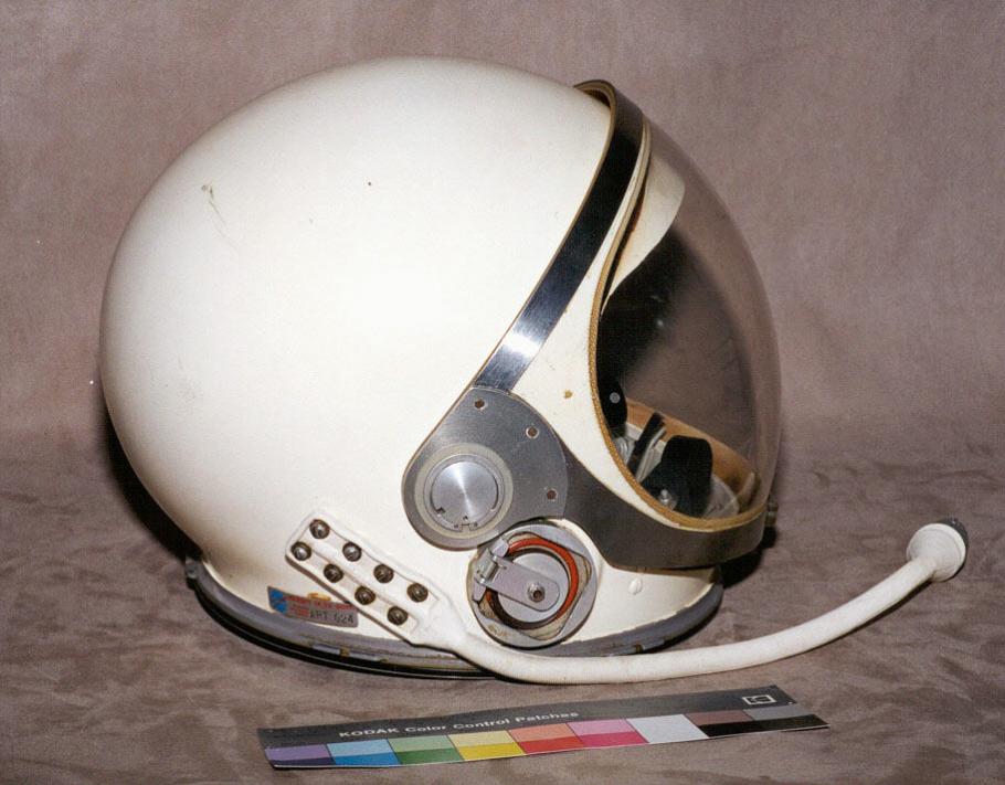 Helmet in profile with communication connection visible. 