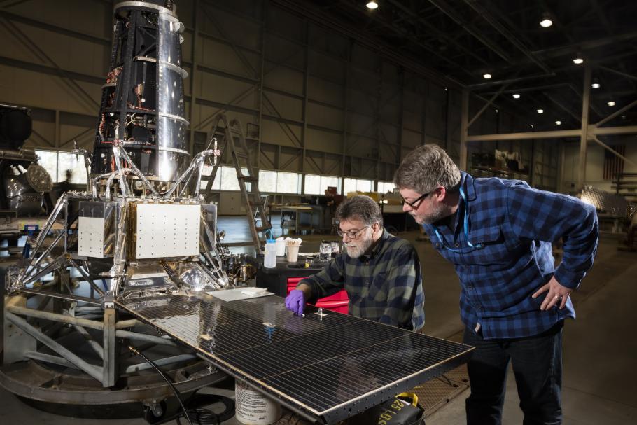 Museum conservator David Blanchfield and space history curator Matt Shindell examining the Ranger 7 spacecraft