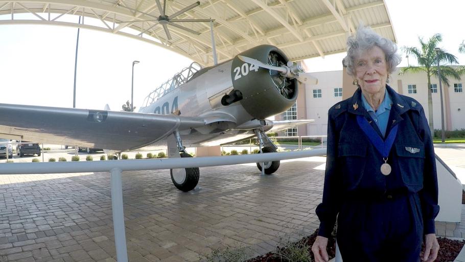 Bernice Haydu, stands next to an AT-6 Texan in 2016