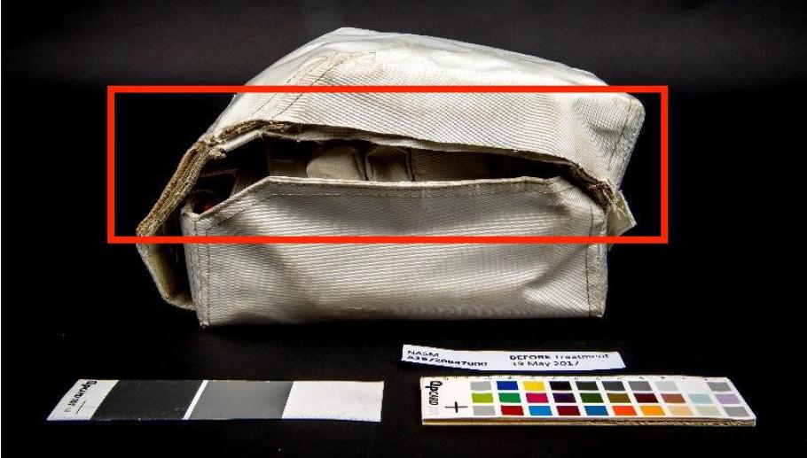 Before conservation, a section of the container’s lid is missing on the left side of the medical kit (indicated in red).