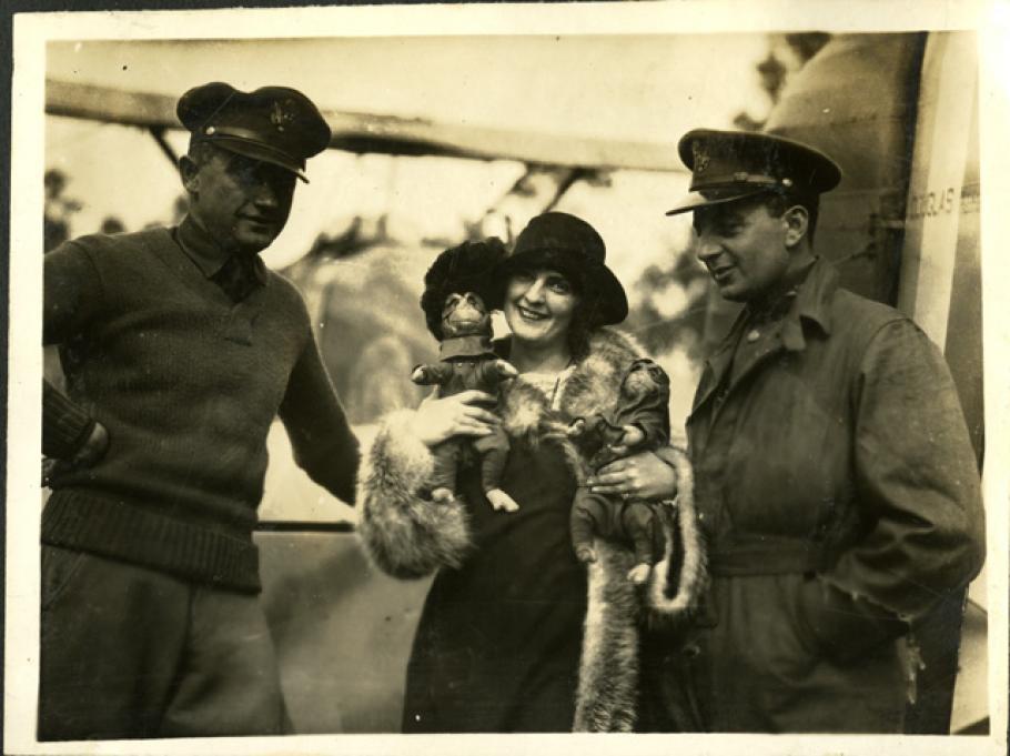A woman holding two monkeys