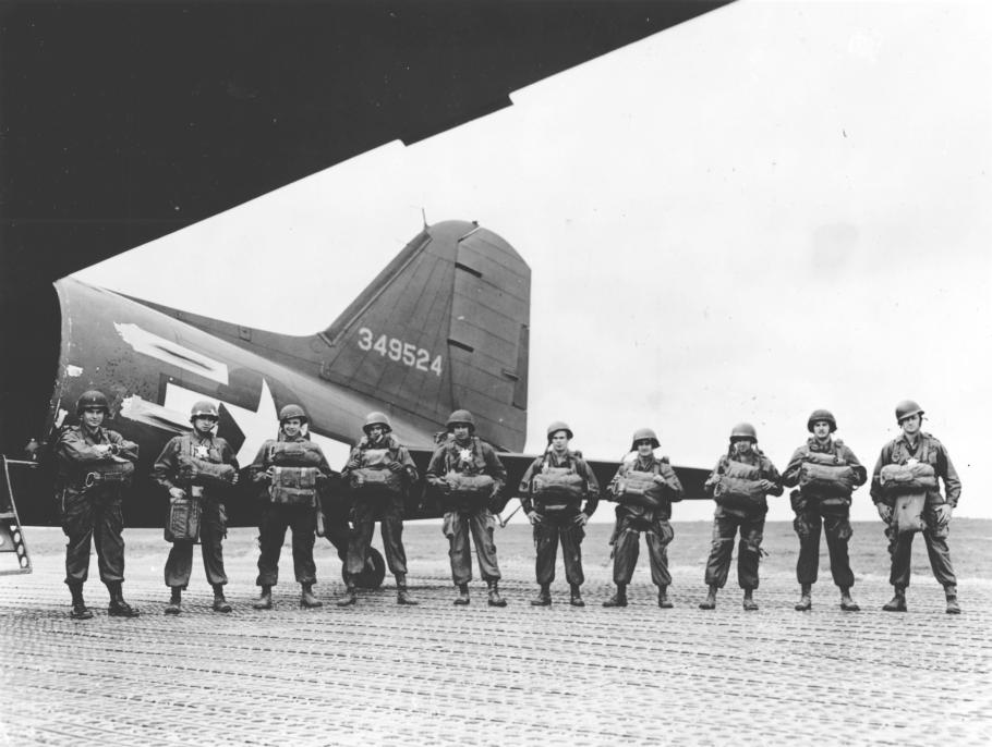 row of men men standing in front of an aircraft