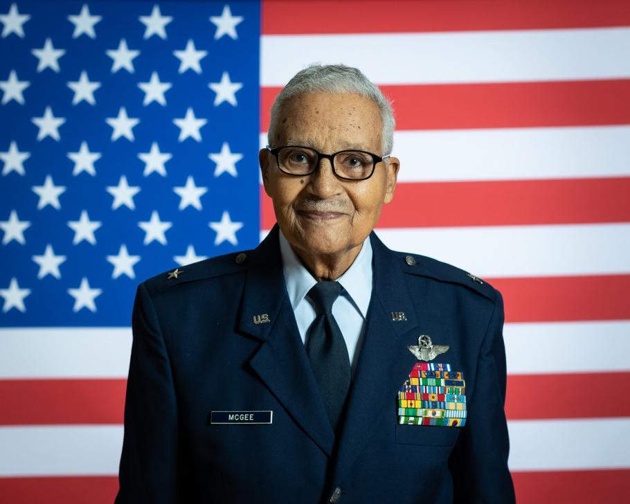 Man in military uniform in front of American flag