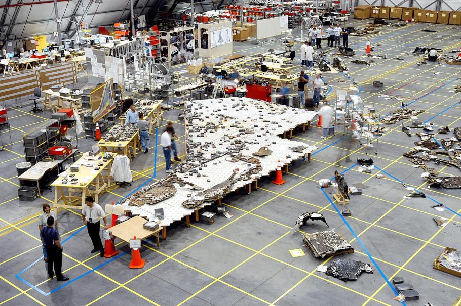 In Kennedy Space Center’s Reusable Launch Vehicle hangar, investigators placed recovered fragments of the underside of Columbia’s left wing onto a table that showed their relative position on the wing. 