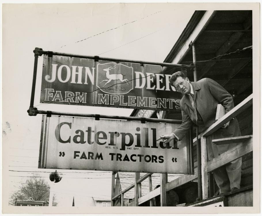 Man points to sign for caterpillar tractors