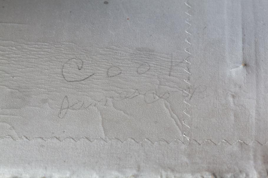 Close up of a signature found on the gray fabric of the Spirit of St. Louis
