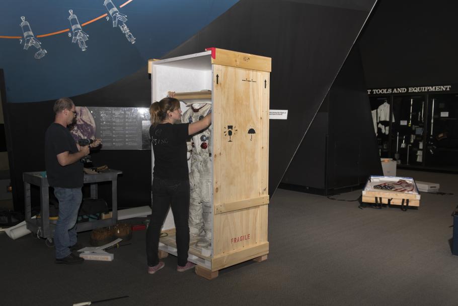 Buzz Aldrin's Apollo 11 spacesuit&nbsp;being moved out of the exhibit case in the "Apollo to Moon" gallery