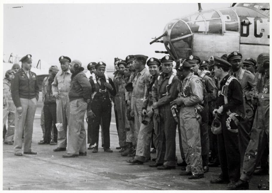 Group of African American airmen in front of aircraft