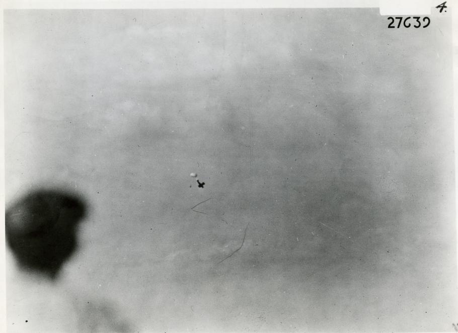 Plane in distance with parachute