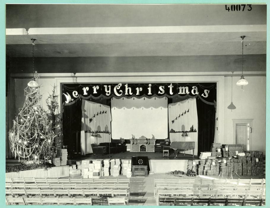 Auditorium decorated for the holidays, Christmas tree on left