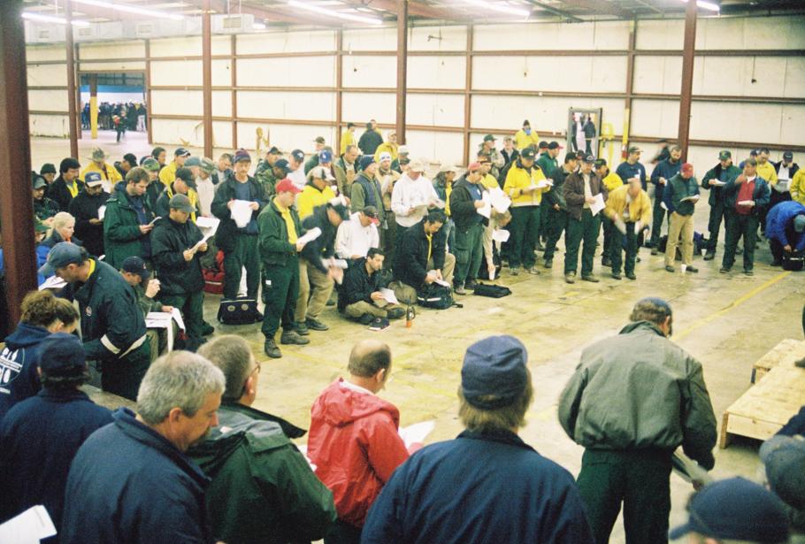 Fire crews gather for a morning briefing in a warehouse in Palestine, Texas on February 23, 2003 before venturing out to search for Columbia debris. 