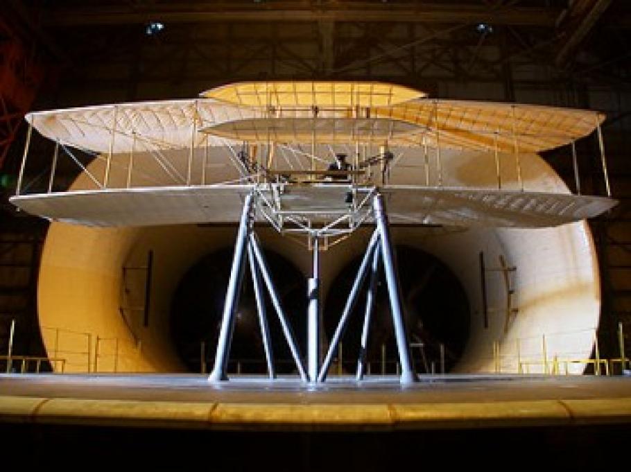 A replica of the Wright Flyer before a wind tunnel.