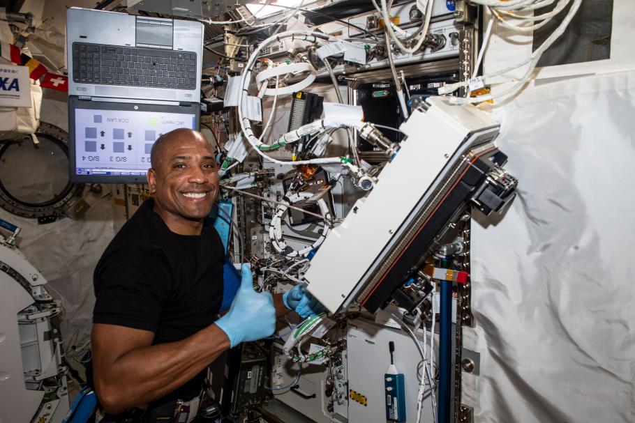 NASA astronaut and Expedition 64 Flight Engineer Victor Glover is pictured inside Japan's Kibo laboratory module installing research gear. He is looking at the camera and smiling. He is giving a thumbs up!