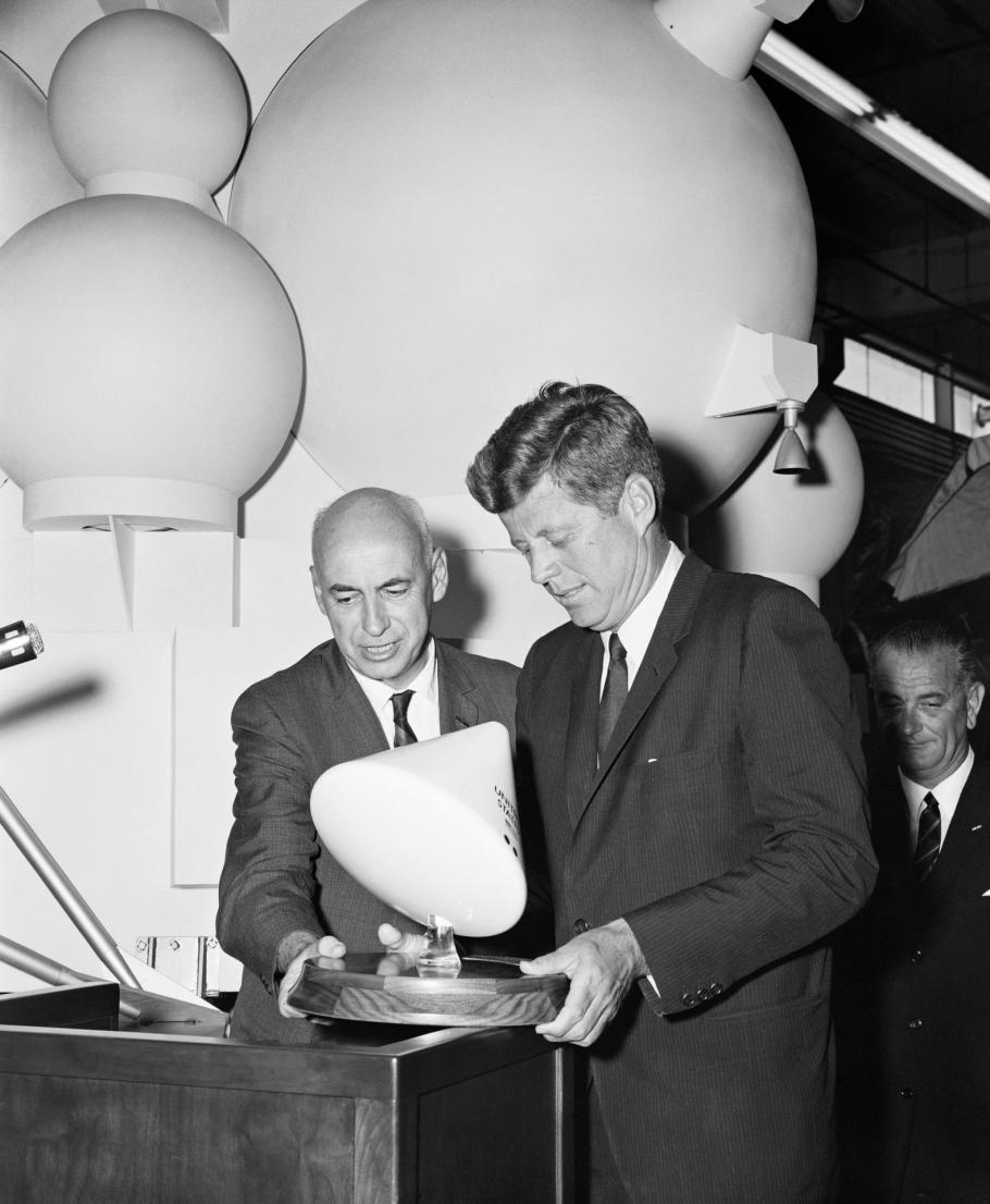 Man holding command module model with John Kennedy