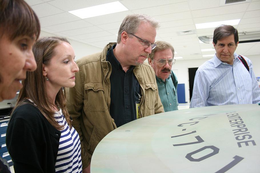 &nbsp;Denise Okuda, Ariel O’Connor, John Goodson, Rick Sternbach, and Adam Schneider study the original weathering streaks that had been subtly painted on the top of the saucer prior to filming
