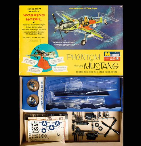 The open box of a Phantom Mustang P-51D model kit reveals plastic parts, many of which are transparent, and U.S. Air Force decals.