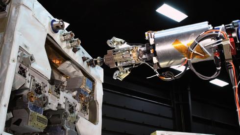 A mechanical arms approaches a panel of instruments, as mission controllers on Earth learned to remotely command the Canadian Dextre robot (mounted on the International Space Station) to perform a range of servicing tasks.