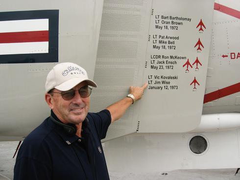 Fifty years after flying aircraft in Vietnam, Jim Wise returns to the deck of the USS Midway, which is now a museum. He points to markings on an F-4 that represent the MiGs shot down by VF‑161.