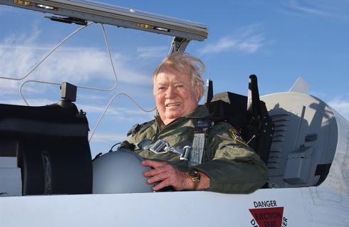 At a senior age, Joseph Kittinger sits in a cockpit of an airplane.