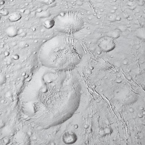 A close-up image of spherical craters on a grey surface.