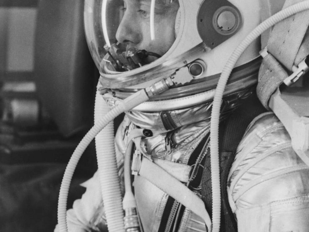 A black and white image of Alan Shepard in a pressure suit.
