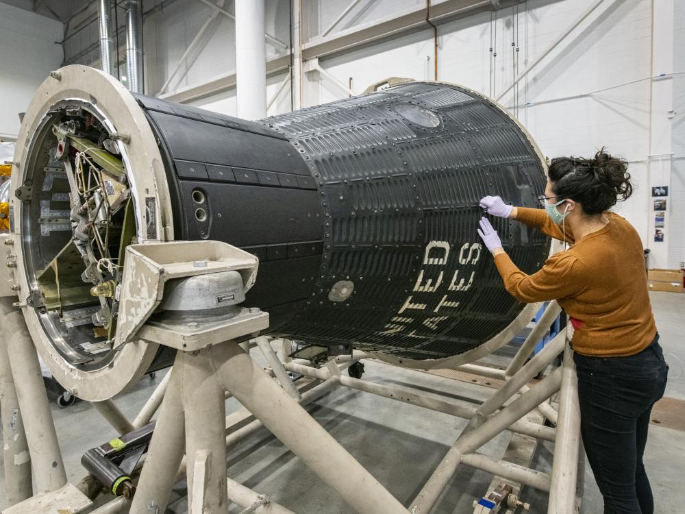 A conservator works on Freedom 7