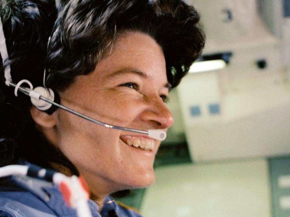 Sally Ride in astronaut flight suit and headset 