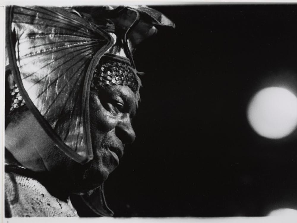 A black and white photograph of a man in an Egyptian style headdress