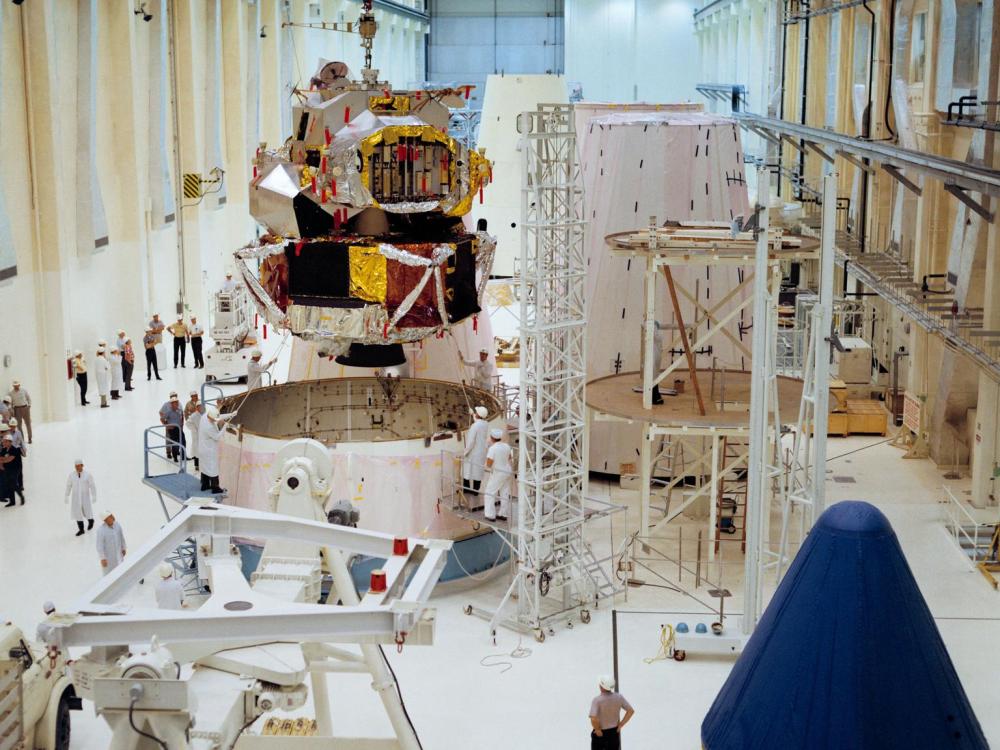 A color photograph of Lunar Module 1 being moved into position for mating with Spacecraft Lunar Module Adapter 7 in the Kennedy Space Center's Manned Spacecraft Operations Building.