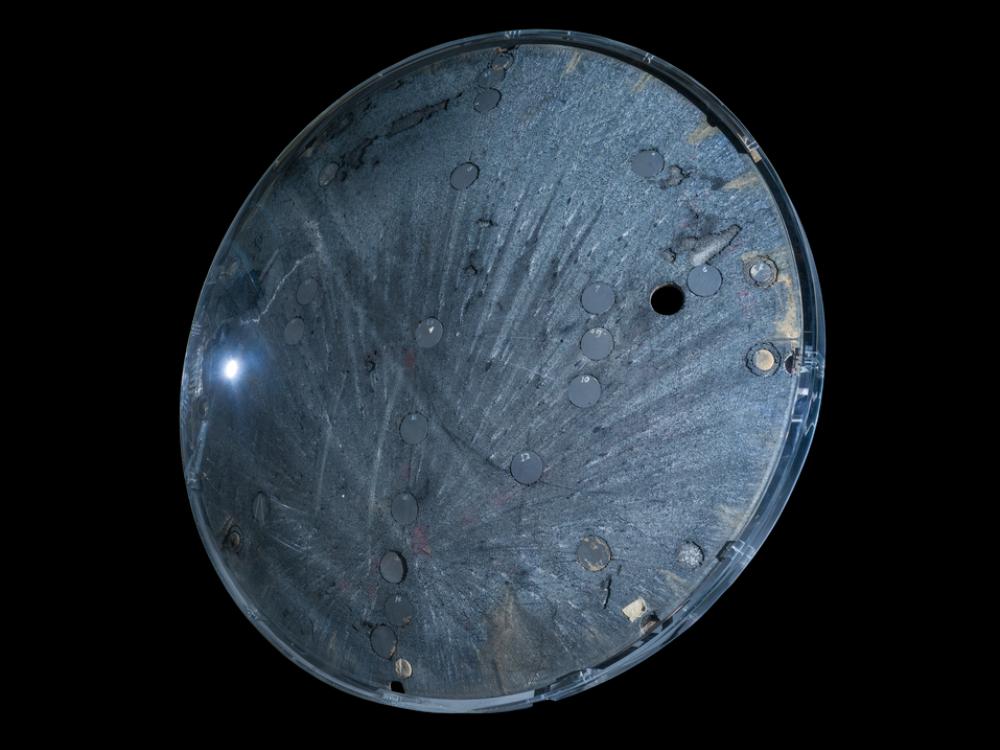 Underside view of a space capsule. The background of the image is black. 