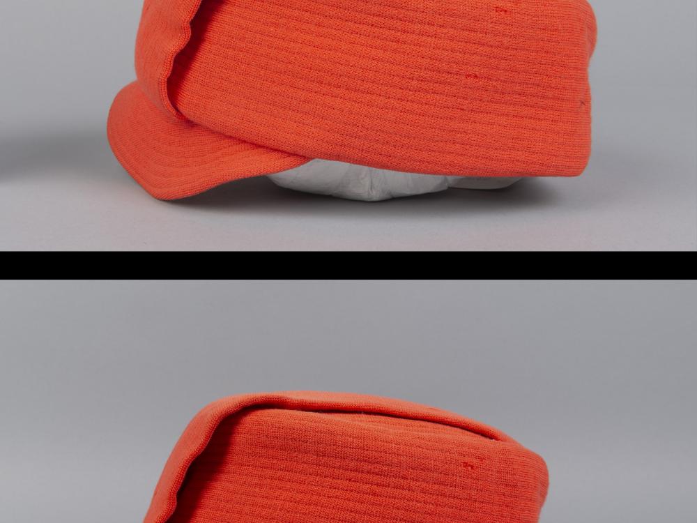 Orange flight attendant hat compared side by side with different viewing angles. Both photographed against a white-grey backdrop.