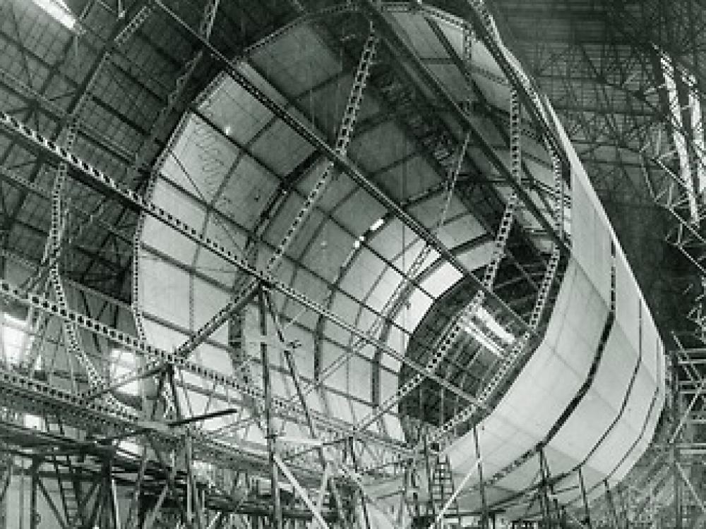 The framework of an airship. Half of the frame is covered in material.