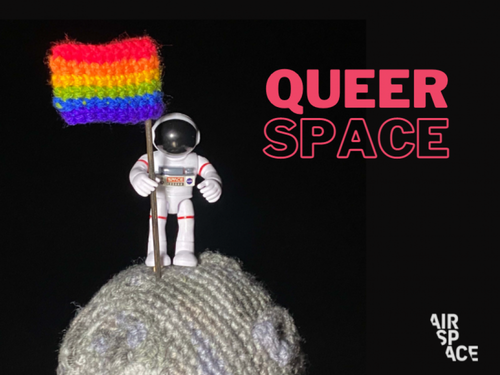 Astronaut standing on crocheted Moon holding Pride flag, with text next to it that says QueerSpace