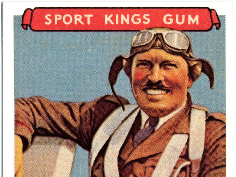 Trading card featuring an illustrated smiling aviator wearing a flying suit, cap, and goggles. The top of the card says Sports King Gum and the bottom says Col. Roscoe Turner.