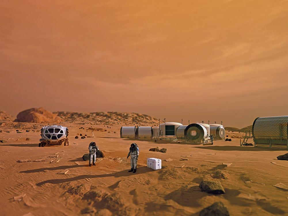 An artist’s depiction of a future base on the surface of Mars shows two astronauts standing in front of cylindrical shelters and a rover.