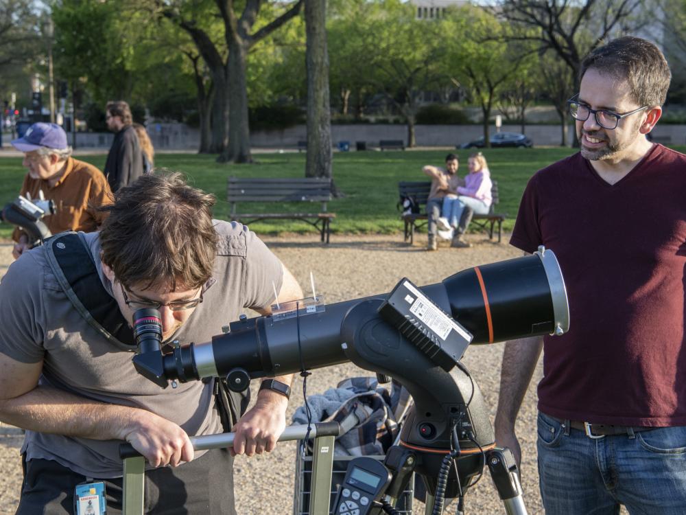 Person looking through a telescope