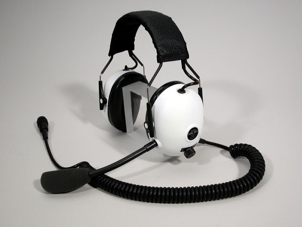 Headphones with white earmuffs and a microphone.