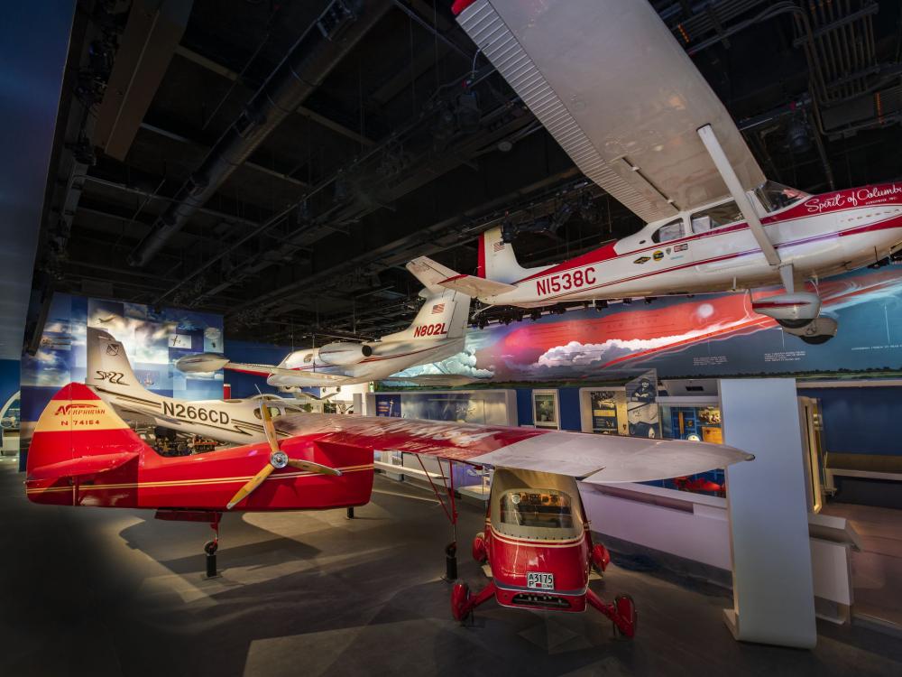 Several red and white airplanes on display at the Thomas W. Haas We All Fly Gallery