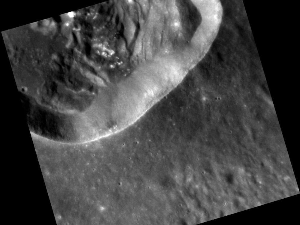 An impact crater where portions of the wall appear slumped or detached. 