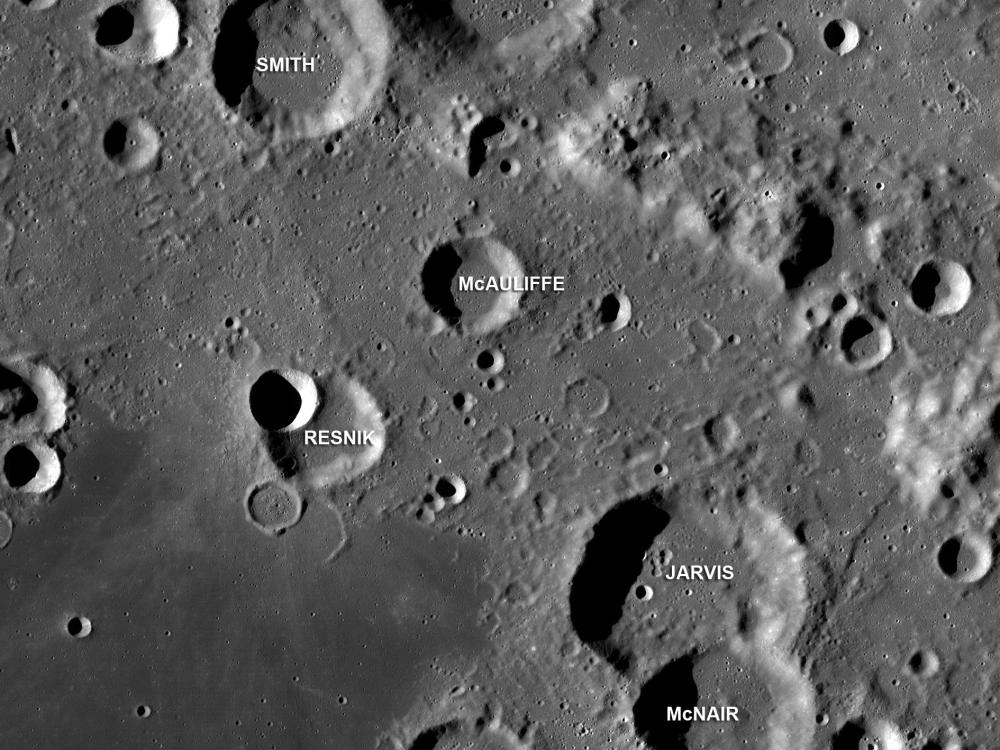 An image of craters on the Moon labeled with the names of the lost crew of Space Shuttle Challenger. From the top of the image to the bottom they are Scobee, Smith, McAuliffe, Resnik, Jarvis, McNair, and Onizuka.