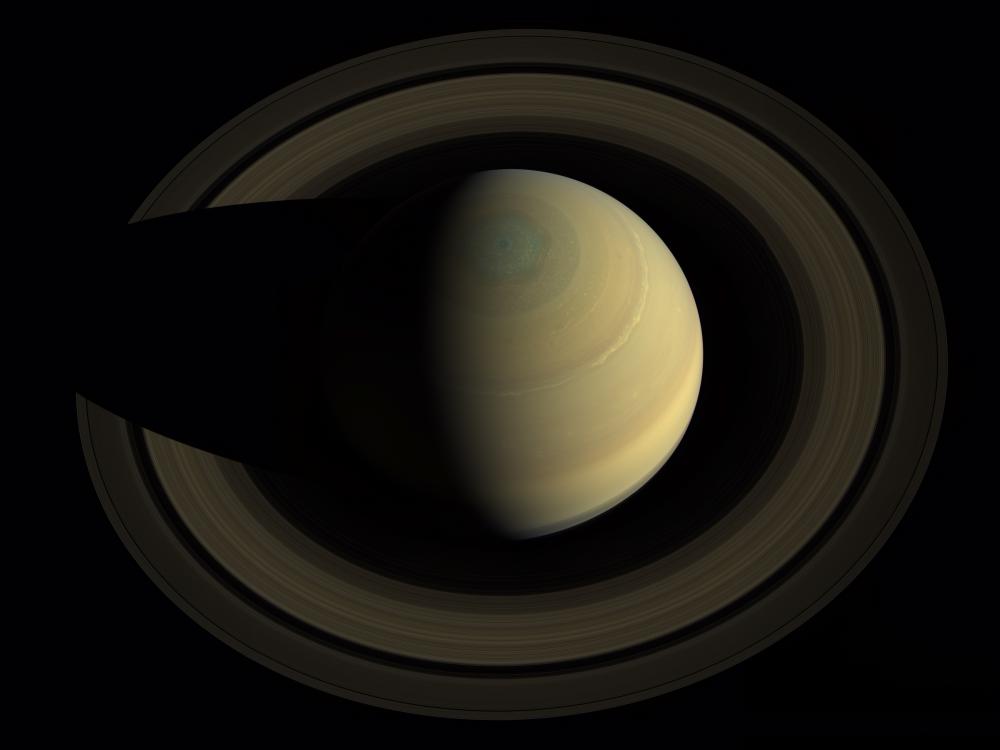 A three-fourths view of Saturn looking down from the top.