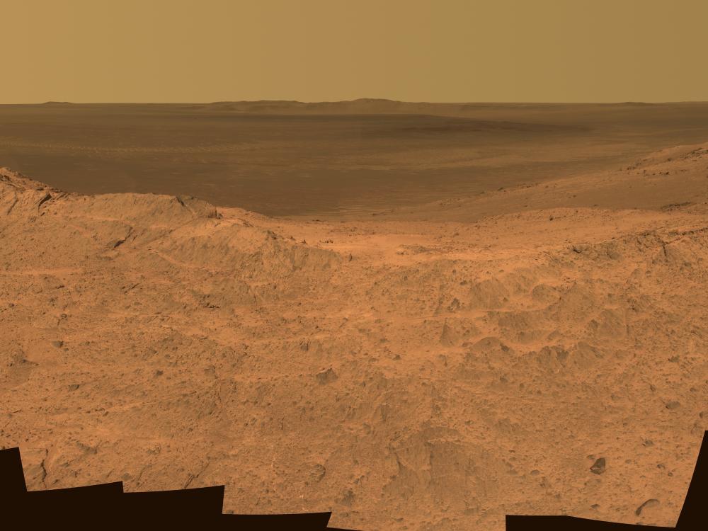 A panoramic view of the dusty red terrain on Mars.