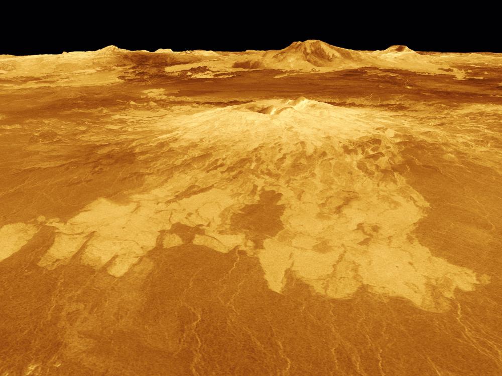 The surface of Venus with Sapas Mons at the center and various ridges in the background.