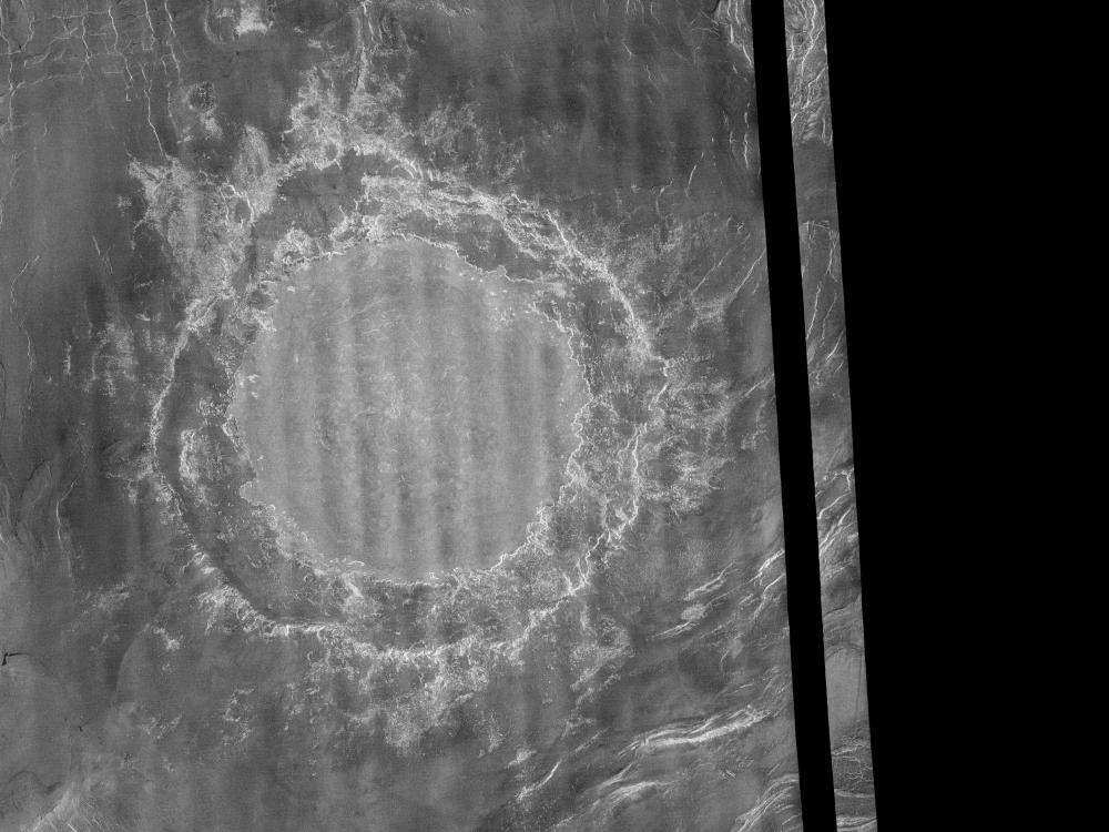 An image of a large impact crater on the surface of Venus.